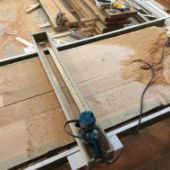 Wood countertop being glued and routered.