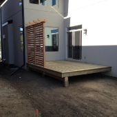 Custom patio construction with privacy wall.