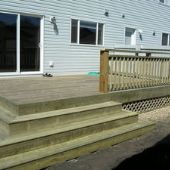 Wood patio with steps and railing. Custom construction.